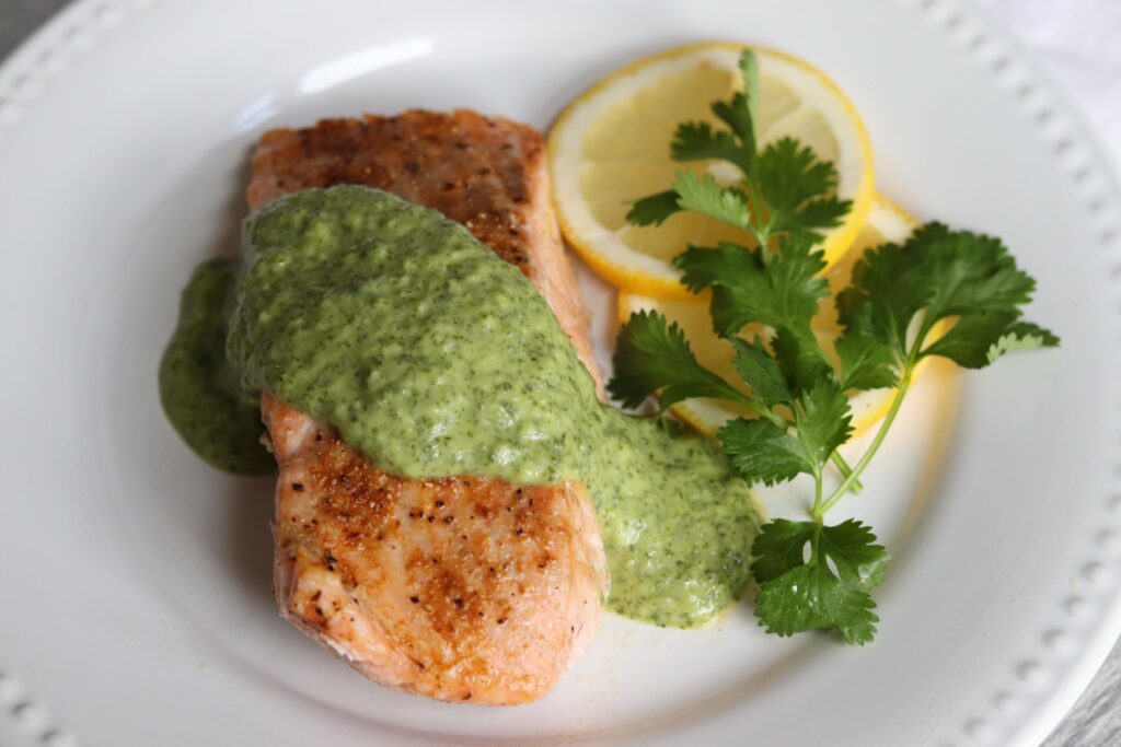Pan-Seared Salmon with Cilantro Crème plated close up 